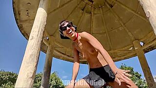 Skinny Latina dances topless flashing hairy pussy thong and small tits publicly