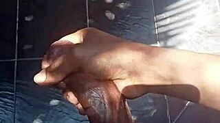 guy casually strokes his throbbing cock outdoors feeling the breeze on his balls