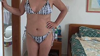 beautiful curvy beach babe slips into bikini flashing her big natural assets seductively