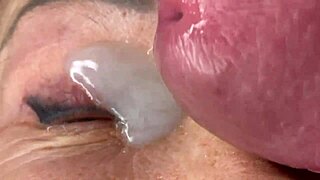 mature lady takes massive facial cumshot right on her eye