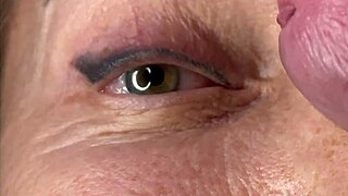 mature lady takes massive facial cumshot right on her eye