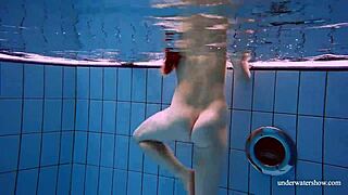 Redhead Marketa strips from white dress underwater in public pool