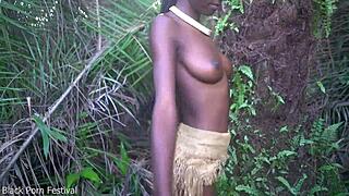 perfect dark african beauty dances half naked in village raffia outdoors