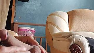 he strokes his throbbing cock alone in the living room shadows