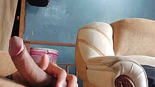 he strokes his throbbing cock alone in the living room shadows