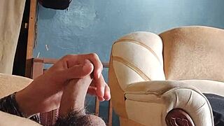 he strokes his throbbing cock alone in the living room shadows