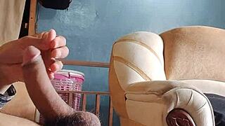 he strokes his throbbing cock alone in the living room shadows