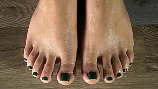 Intensely wiping oiled latina feet closeup green nails toes fetish