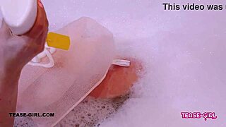 Super cute girl relaxes in a steamy bath on the sofa