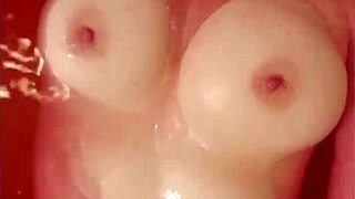 i'm so horny watching this busty babe rub her huge tits in the tub... oops spilled