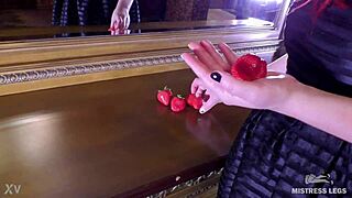 cute wrinkled barefoot toes squeeze juicy strawberry closeup on dresser dirty foot fetish