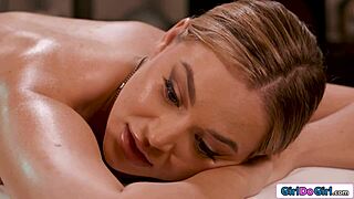 Busty blonde gets petite masseuse's fingers deep in shaved pussy massage