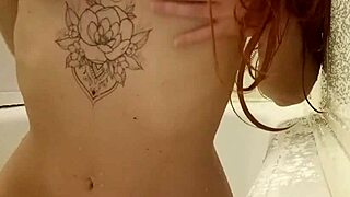 Redhead teen 18+ soaks in steamy bath revealing tattoos and curves
