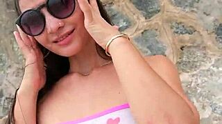 bikini babe flashes teasingly on sunny beach