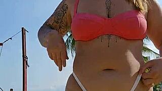 african exhibitionist flashes teasing males while recording beach video provocatively