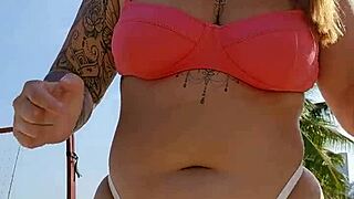 african exhibitionist flashes teasing males while recording beach video provocatively