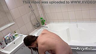 Busty Kecy teases her big tits in bathroom mirror