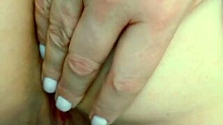 mature beauty caresses her huge shaved pussy lips hungrily