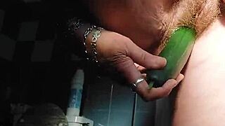 oma stuffs her hairy pussy with a thick cucumber