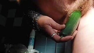 oma stuffs her hairy pussy with a thick cucumber