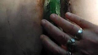 oma stuffs her hairy pussy with a thick cucumber