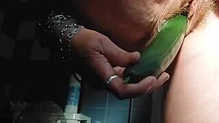 oma stuffs her hairy pussy with a thick cucumber
