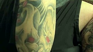 Djrafa tests the couch with a tattooed guy