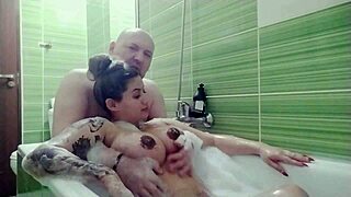 Couple relaxes in a bath with natural features