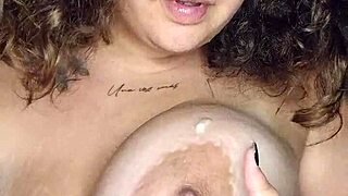 Latina strips and plays with big tits