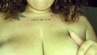 Latina strips and plays with big tits