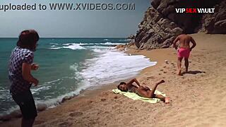 Oiled up ebony babe gets her tits and ass rubbed on a public beach
