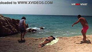 Oiled up ebony babe gets her tits and ass rubbed on a public beach