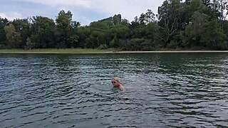 mature woman swims naked outdoors
