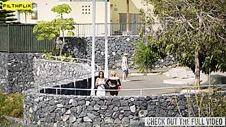 Glam babes share a cock outside in the sun